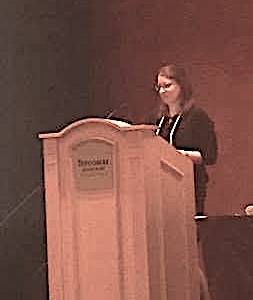 Natalie Jackson speaking at a podium
